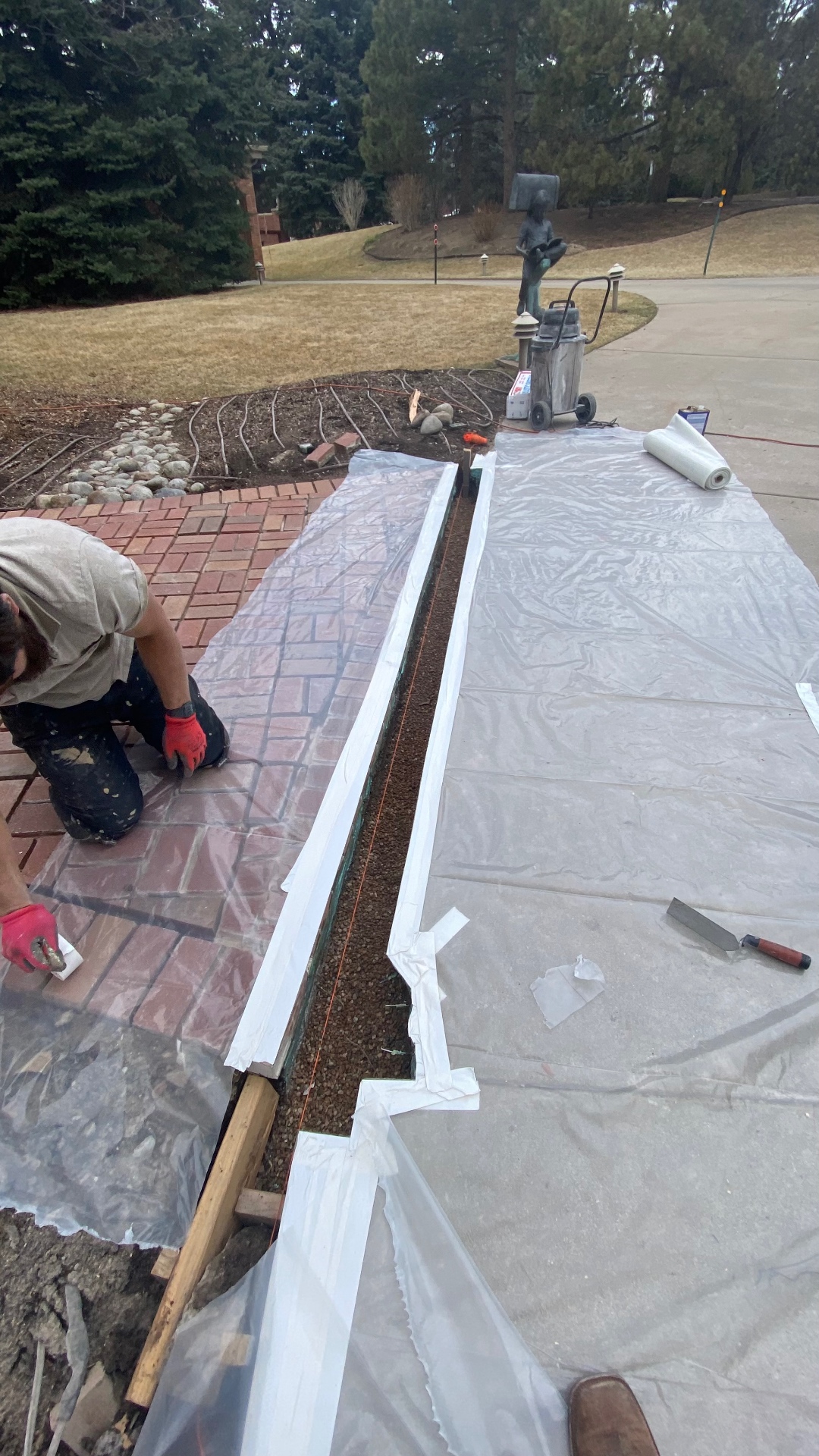 Luna Restorations crew preparing the Cherry Hills brick walkway and drainage channel