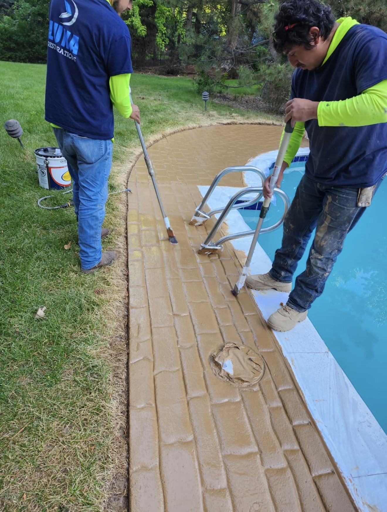 Luna Restorations crew working on the poolside concrete surface