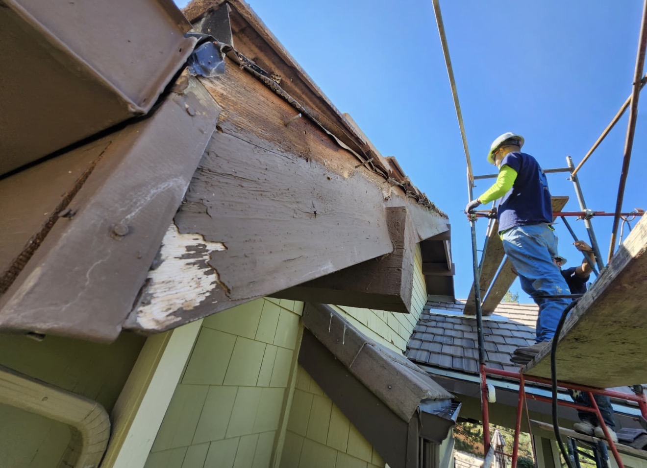 Rotted wood trim and rafter tail repair during the siding restoration