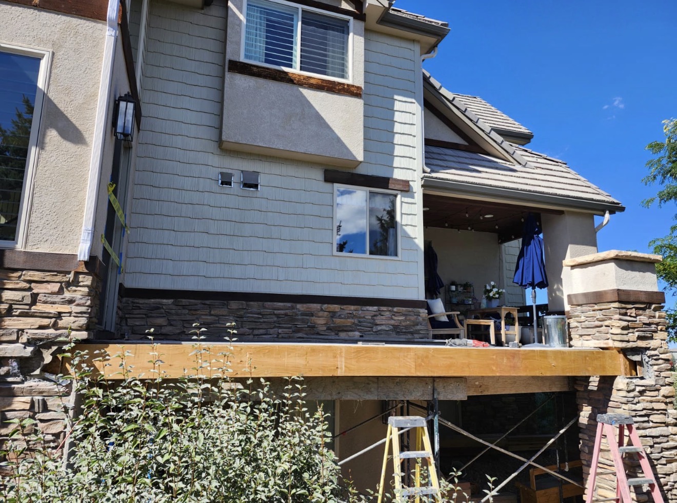 Deck framing rebuilt with new ledger and joists before refinishing