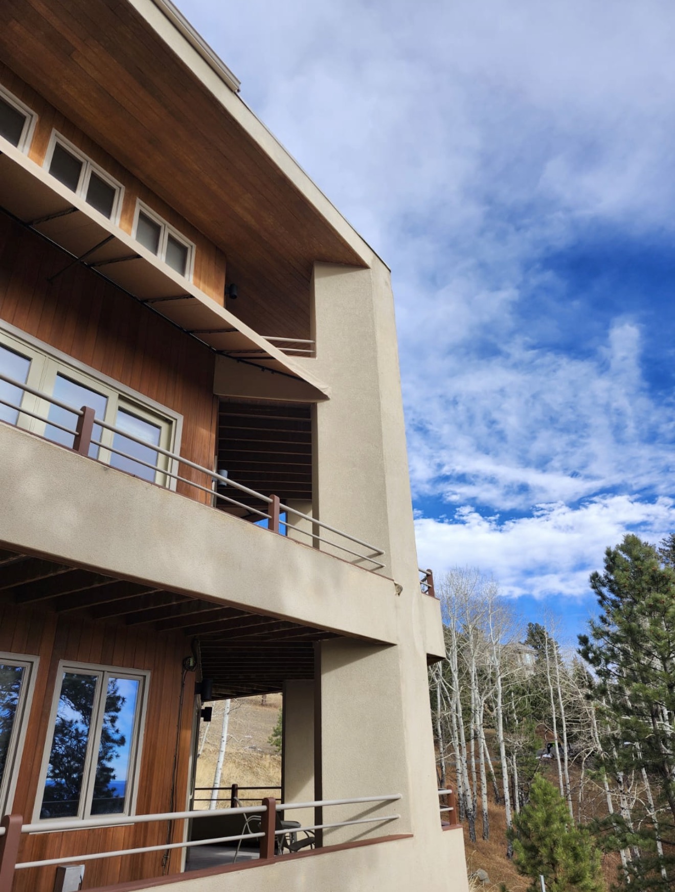 Exterior balconies, stucco walls and wood finishes
