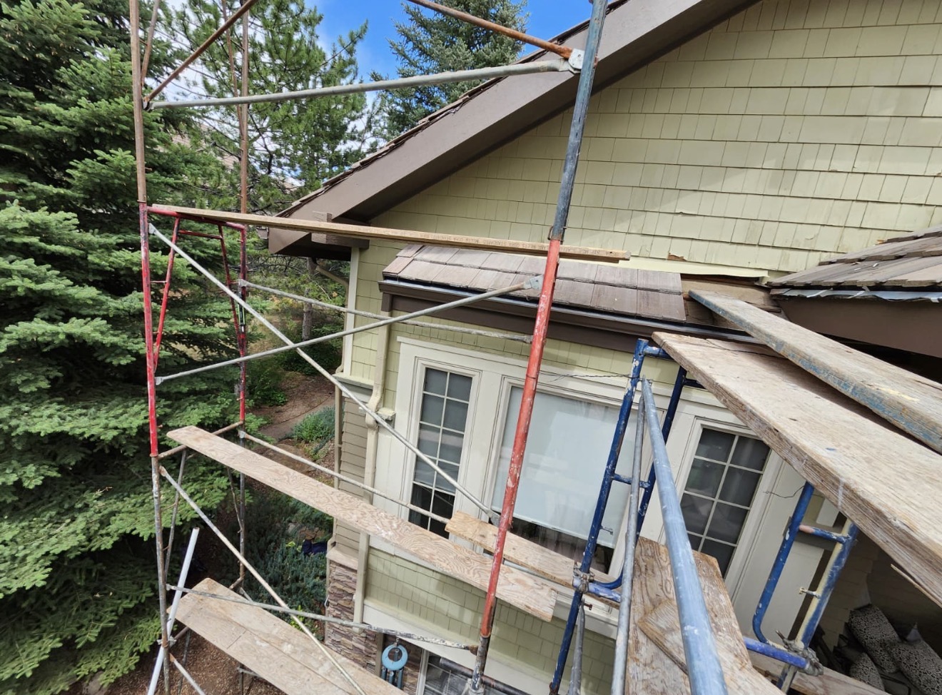 Scaffolding set up for exterior paint preparation on the upper facade